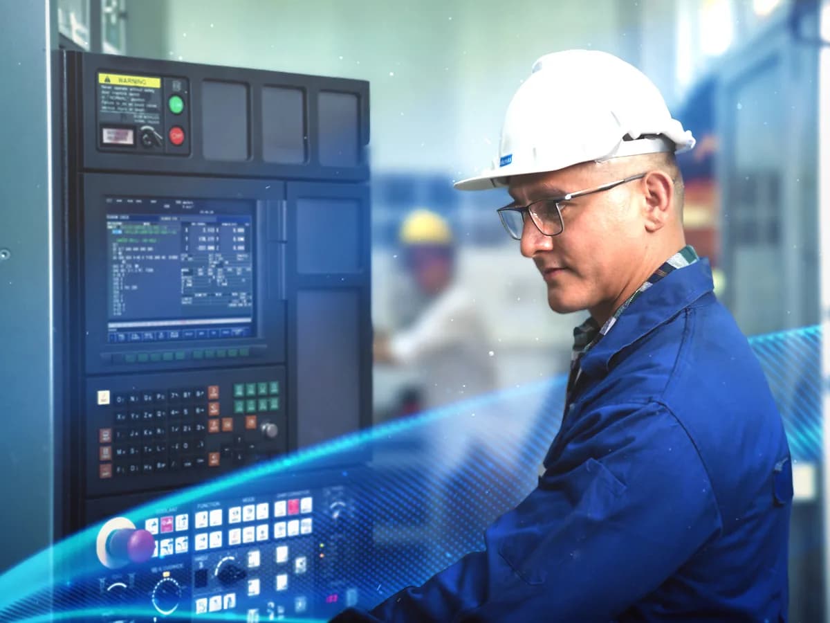 ME Elecmetal operator at a control panel wearing personal protective equipment